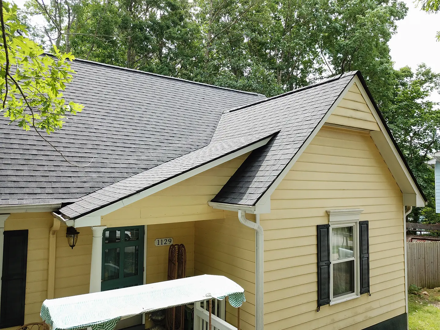 asphalt shingle roof on yellow house northface construction