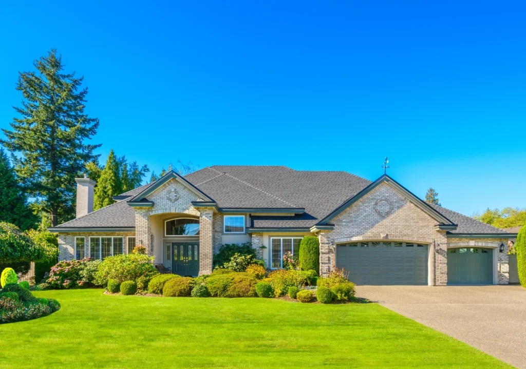 Beige brick house with a brown roof and a green yard in the Twin Cities