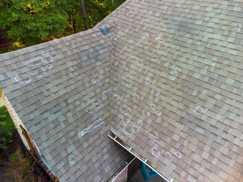 Signs of storm damage to a roof in Blaine