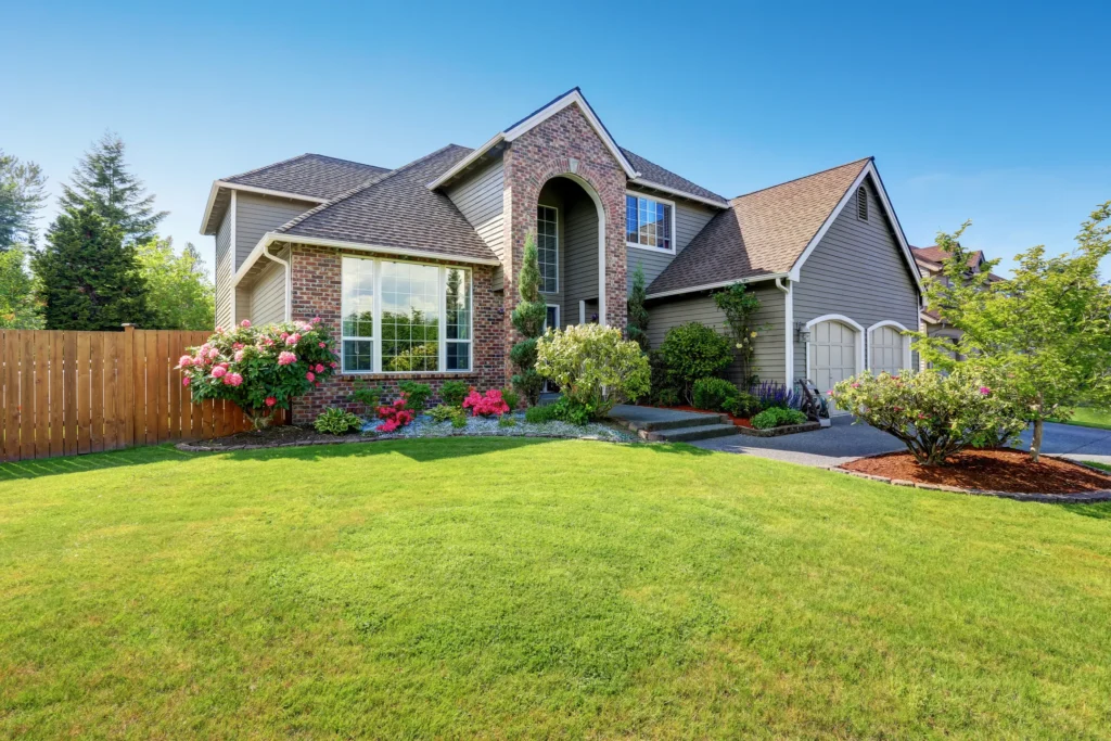 Brown brick house with a bright green lawn in Coon Rapids