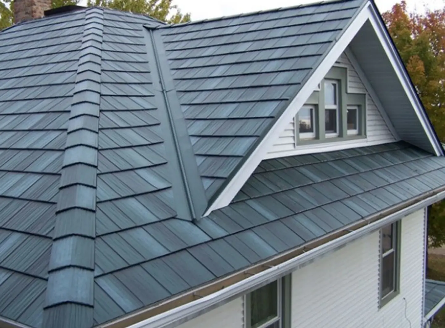 gray composite roofing material on white house northface construction