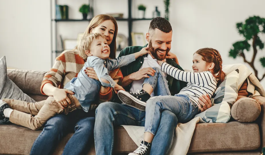 Family sitting together in their house in Maple Grove