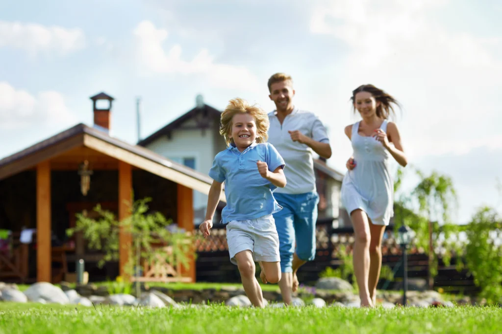 A family running outside of their house.