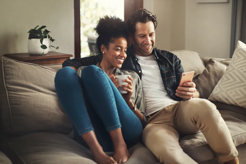 Homeowners sitting together in their living room in Stillwater