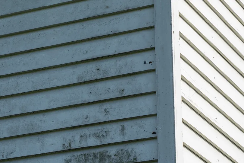 Storm damaged siding on a house in Maple Grove
