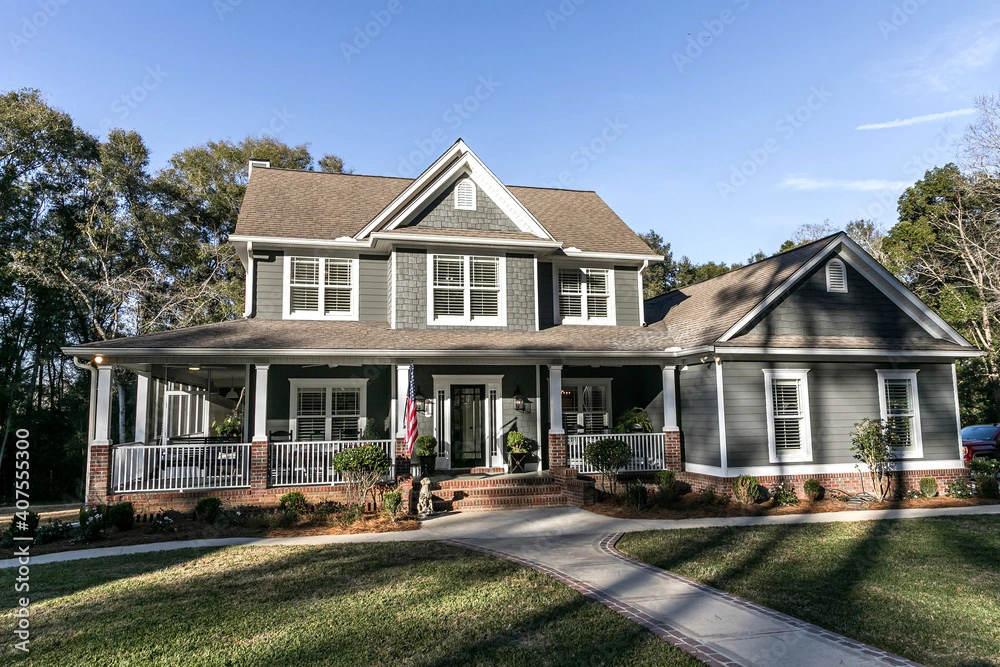 grey siding on large house house with white trim