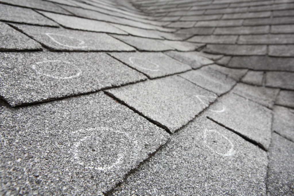 Signs of storm damage with shingles