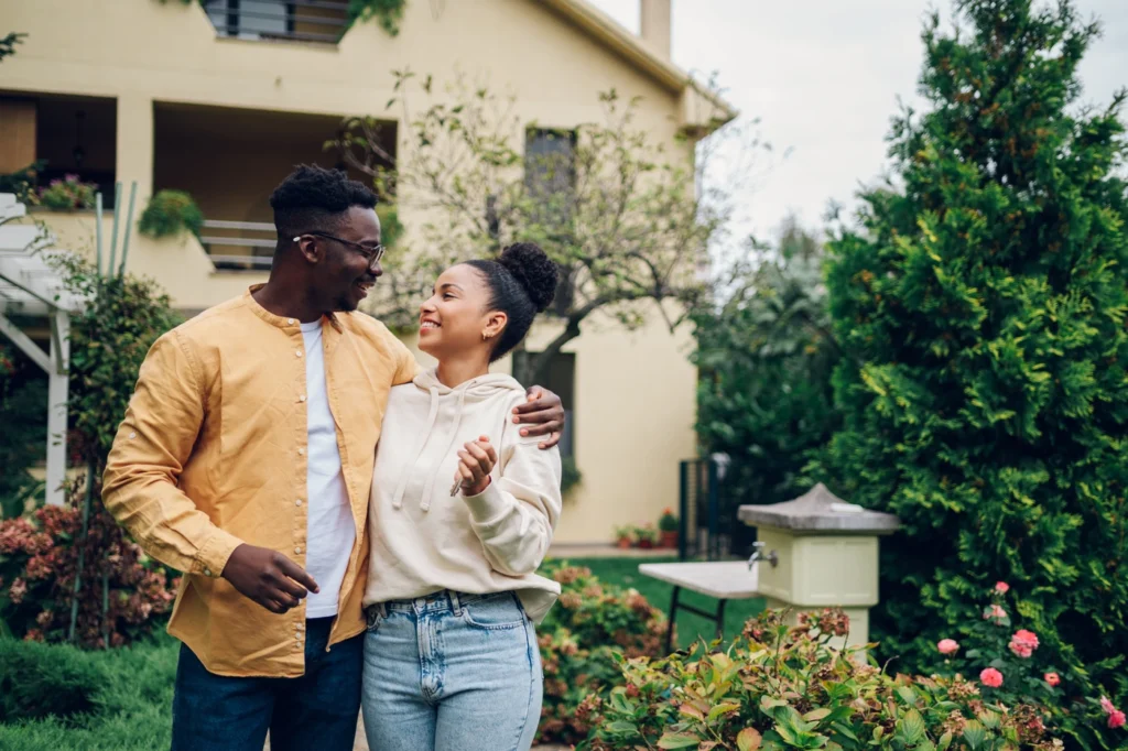 Young homeowners enjoy new home purchase with new roof