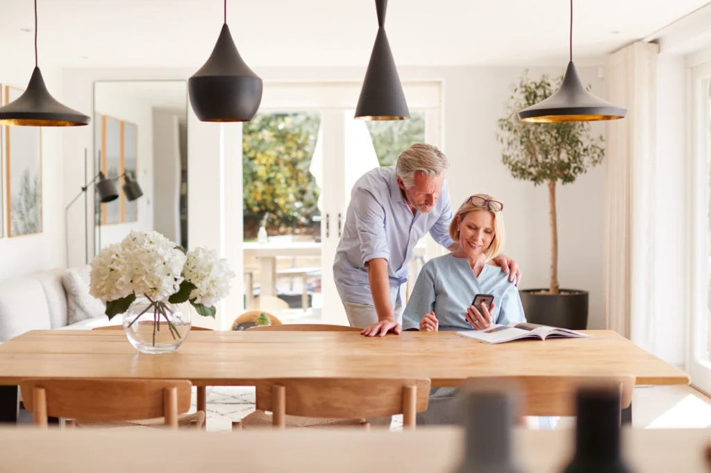 Happy couple at home enjoy new home with new roof