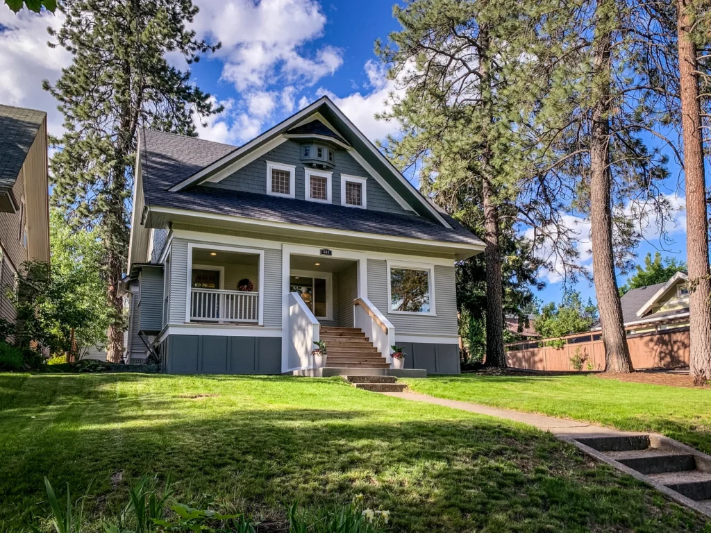 shingle roof replacement on white bear lake home with porch and pine trees in yard