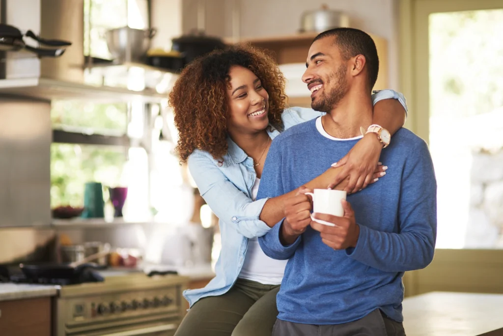 Happy younger couple enjoys time in their home in white bear lake - coffee in kitchen
