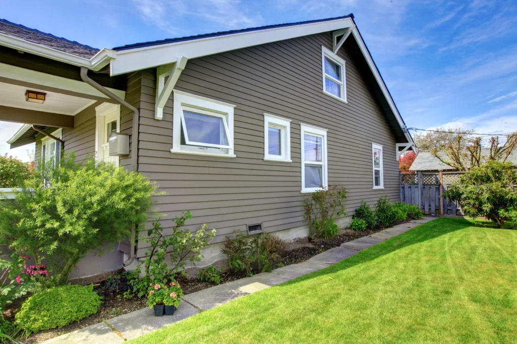 Sleek new siding installation in hudson mn - green lawn and landscaping