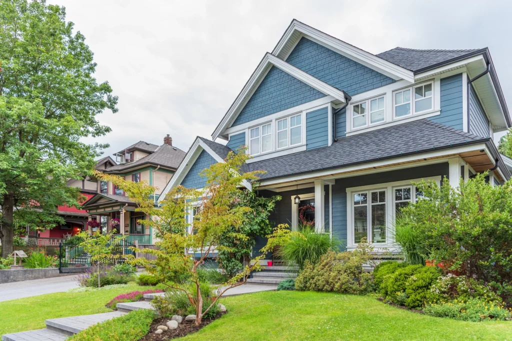 Blue Minnesota home with black gutters installed by Northface Construction