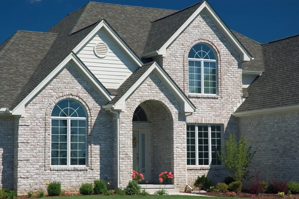 brick house with new asphalt shingle roof