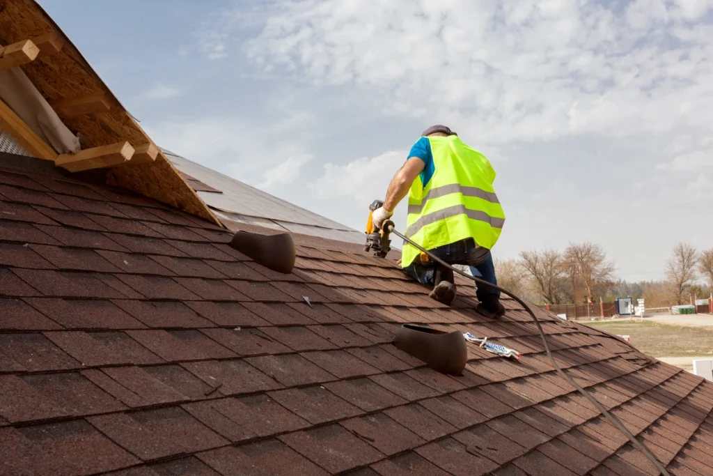 installing shingles on home