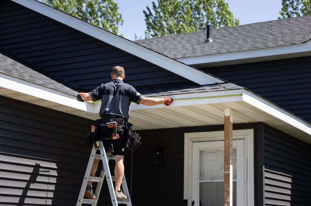 Employee measuring the roof line on a house
