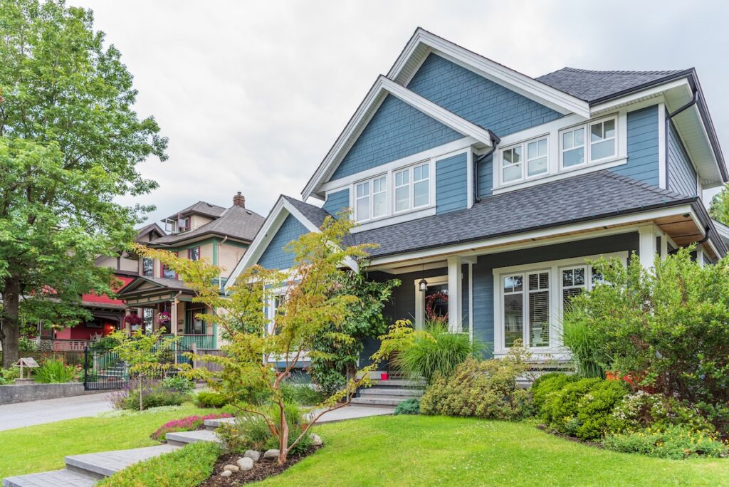 Blue siding on Minnesotan home with lush landscaping