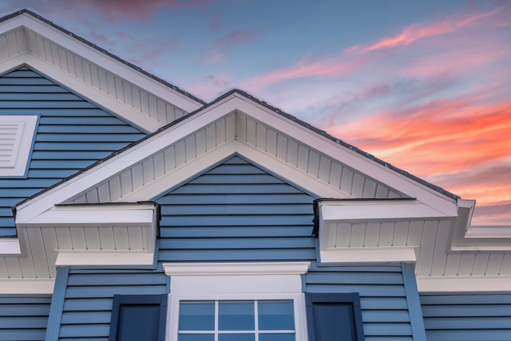 Blue siding on house in front of sunset