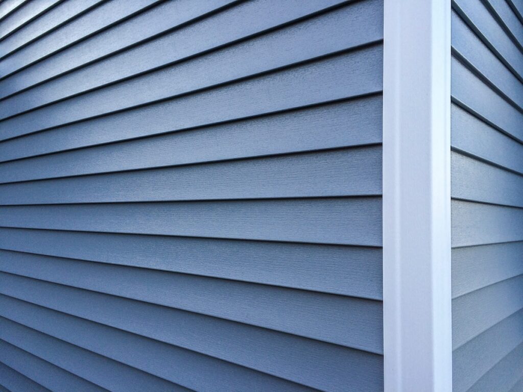 Blue siding corner of house with white trim