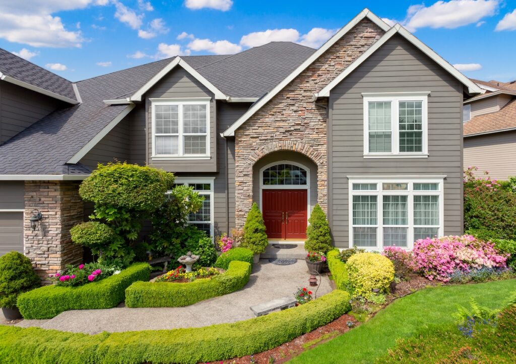 Modern family home with dark siding with accent wall