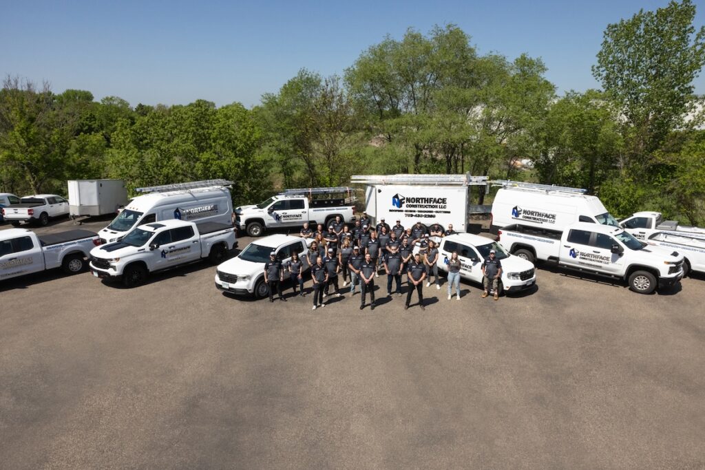 Northface team outside with company branded vehicles smiling