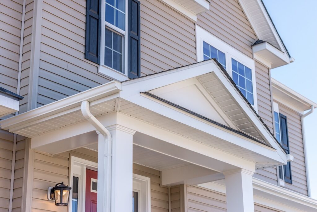 Tan siding on house with porch overhang