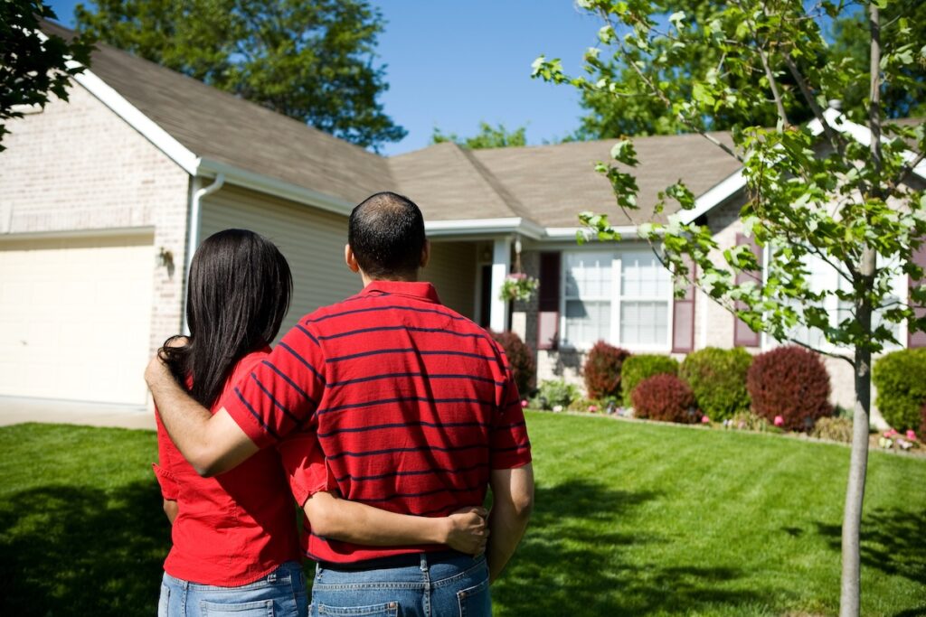 Couple in front of a home.