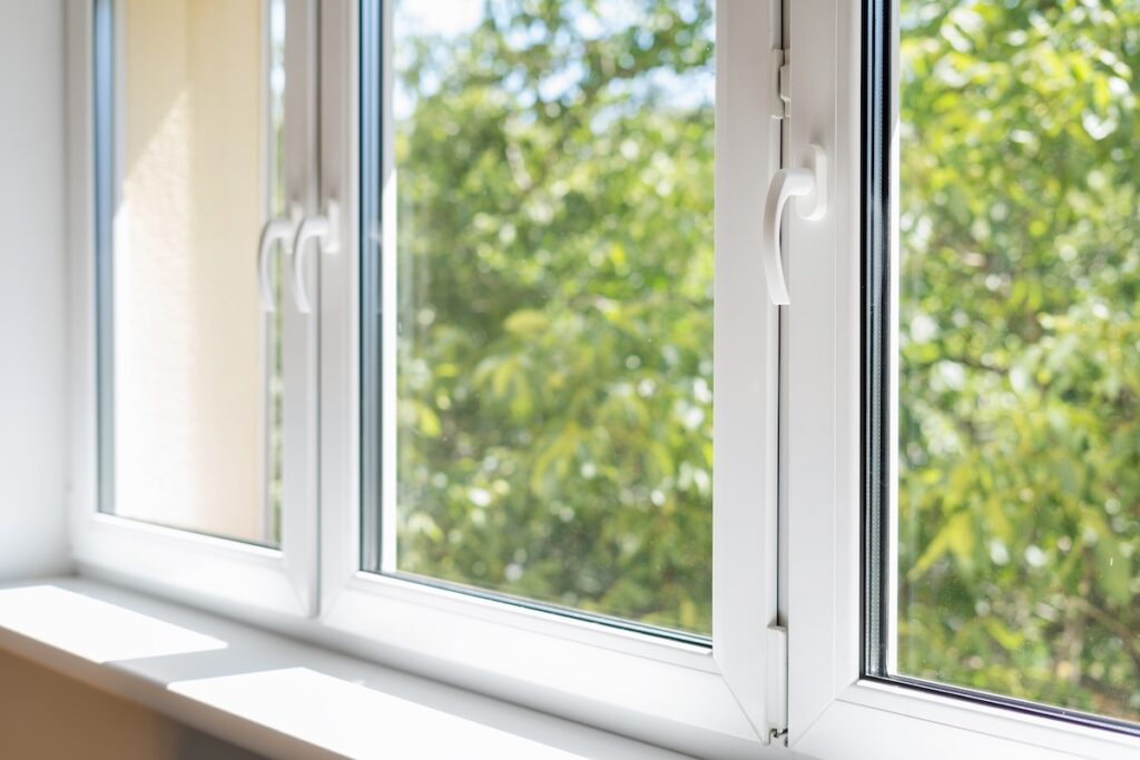 new plastic pvc window with white metal frame installed at modern house