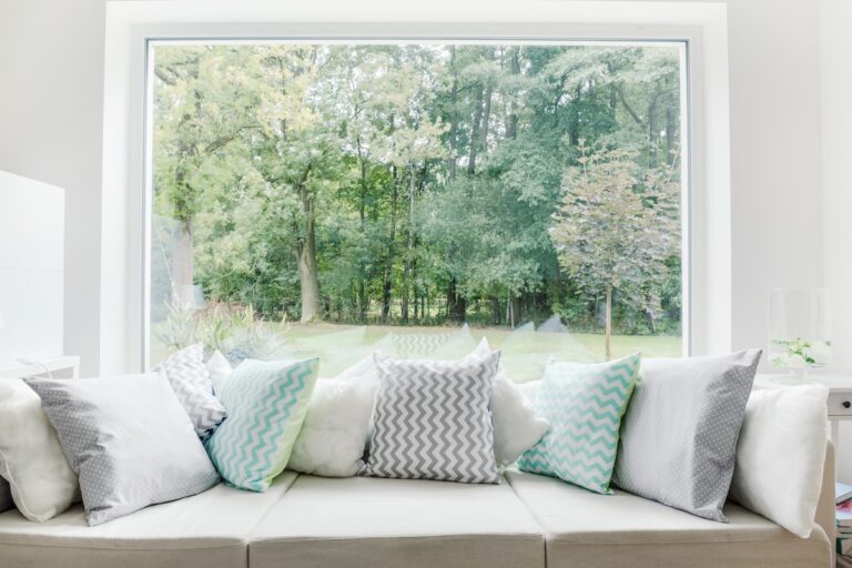 Large picture window behind sofa