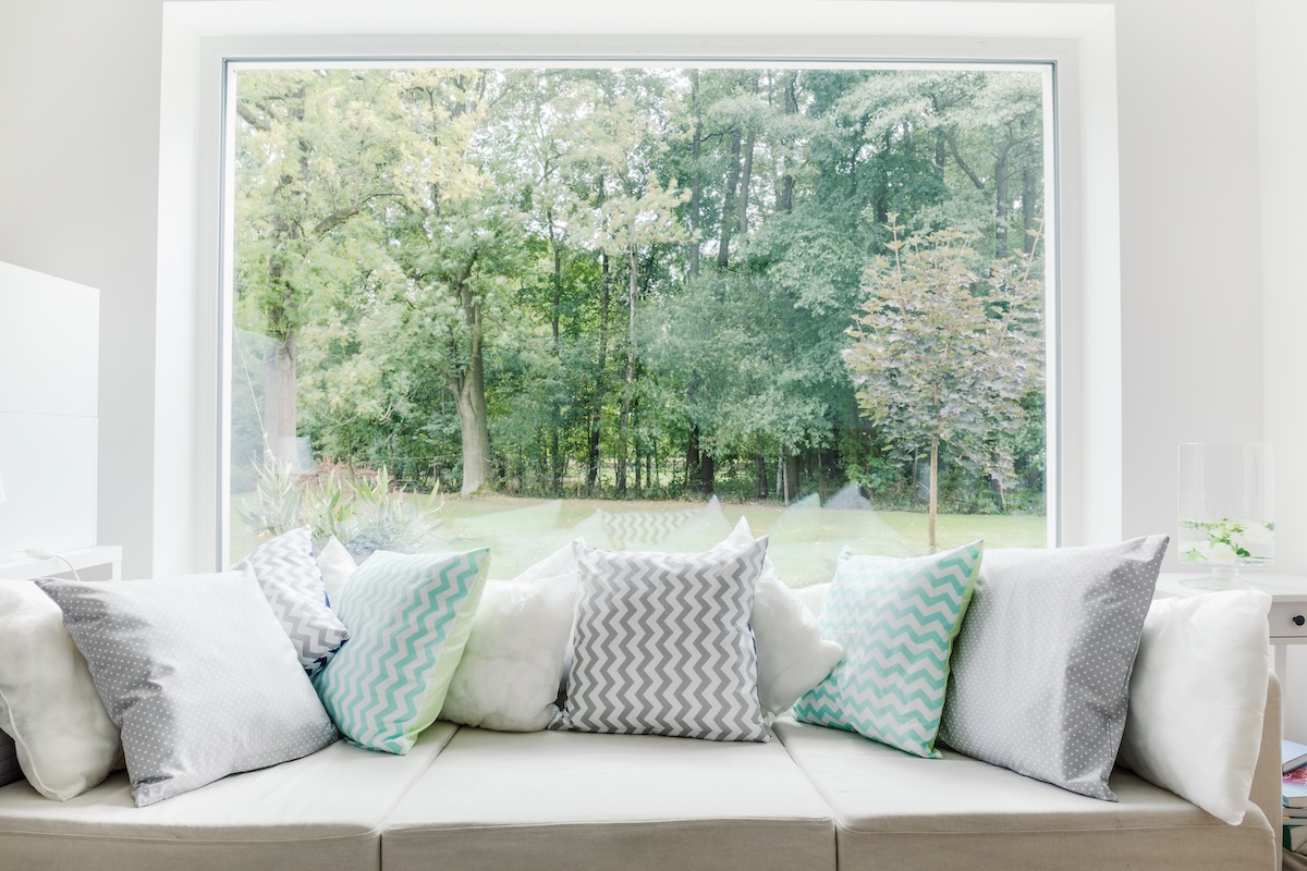 Large picture window behind sofa